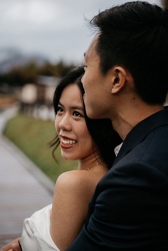 Couple embracing outdoors, smiling