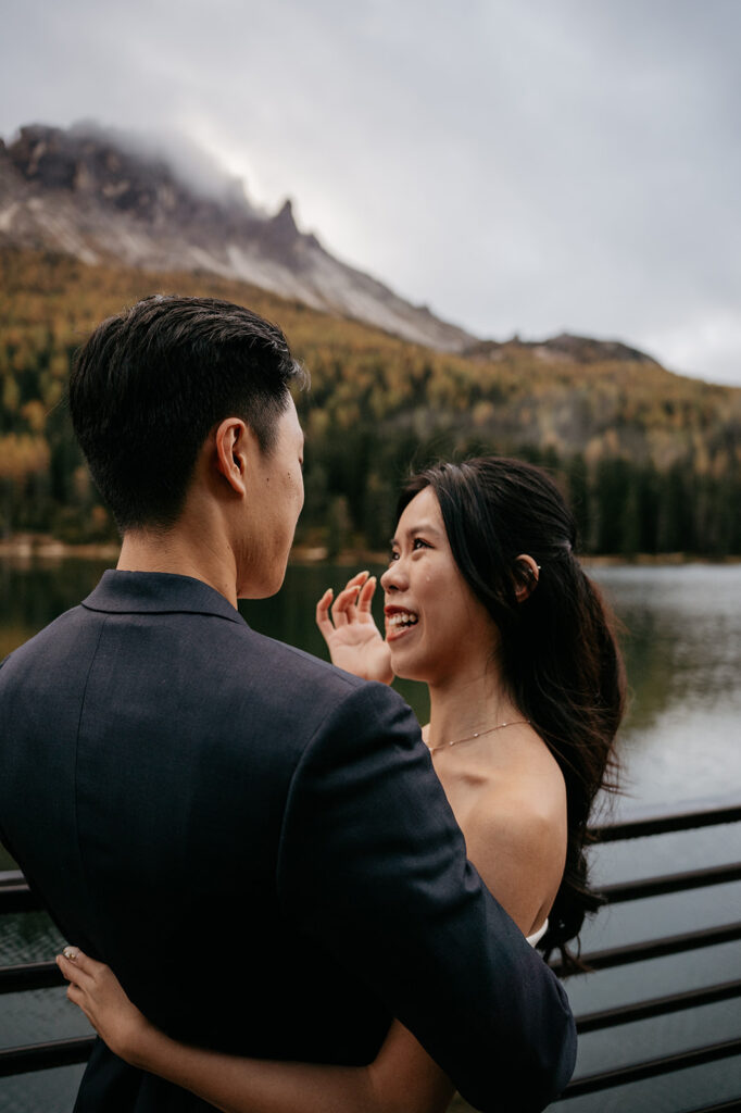 Couple embracing by a scenic mountain lake