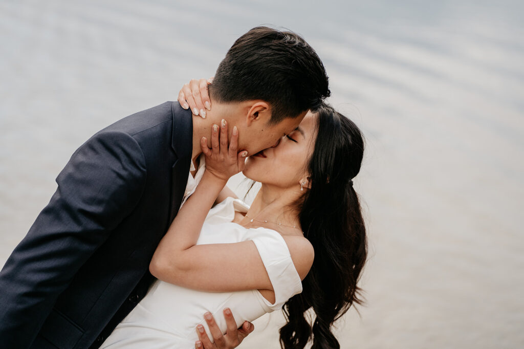 Couple kissing by the water