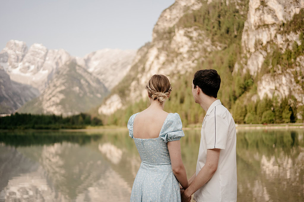 Couple admiring scenic lake and mountains