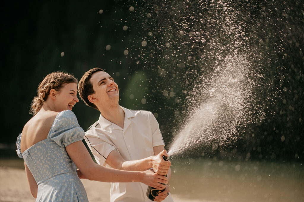 Couple celebrating with champagne outdoors