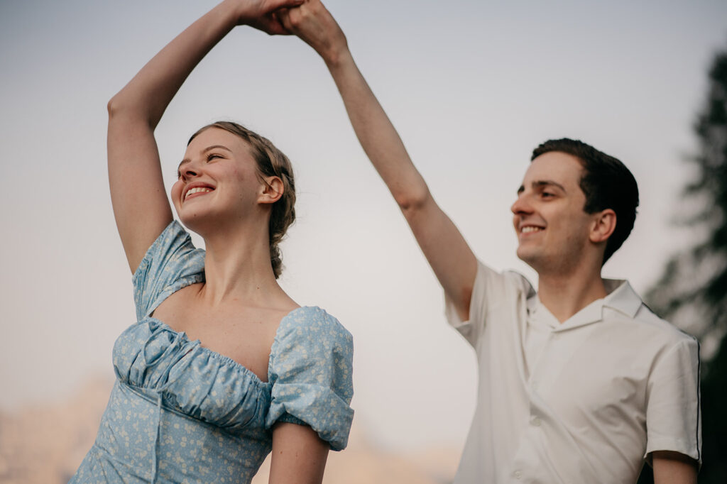 Smiling couple dancing outdoors.