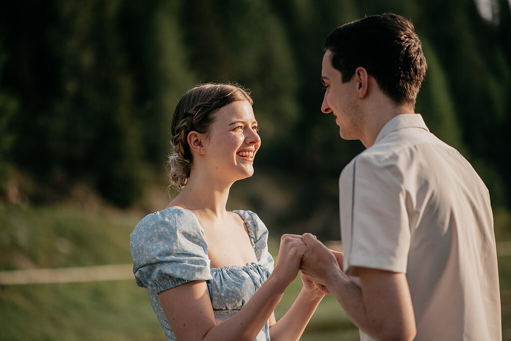 Smiling couple holding hands outdoors