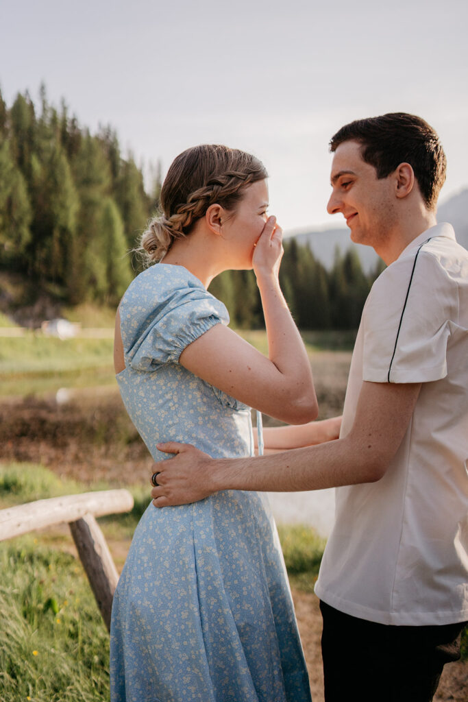 Couple smiling near scenic forest background