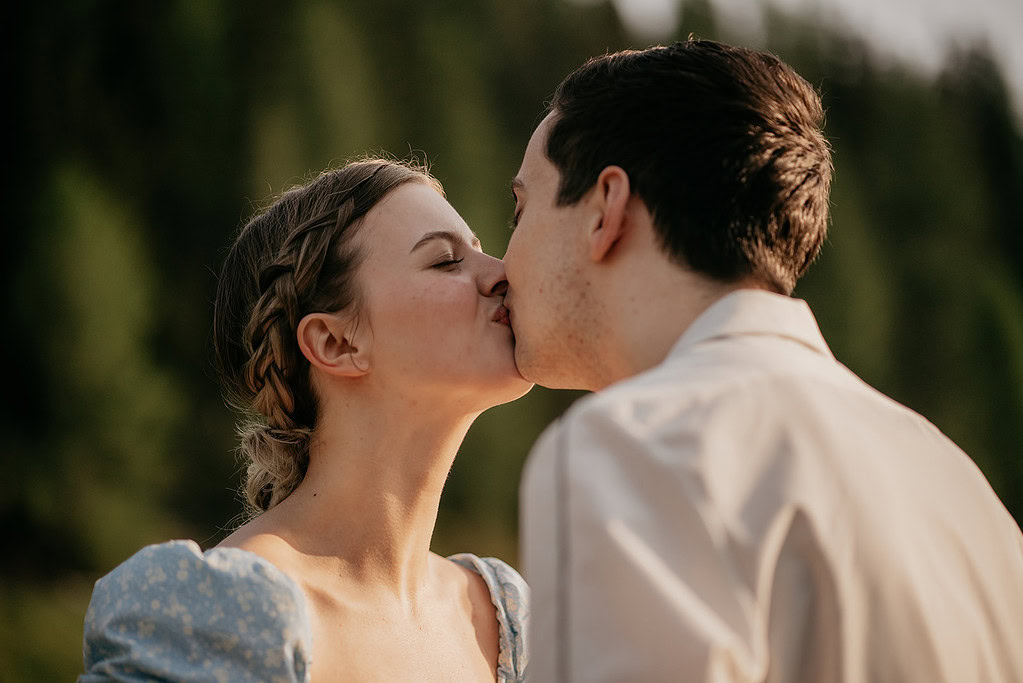 Couple kissing outdoors with blurred background