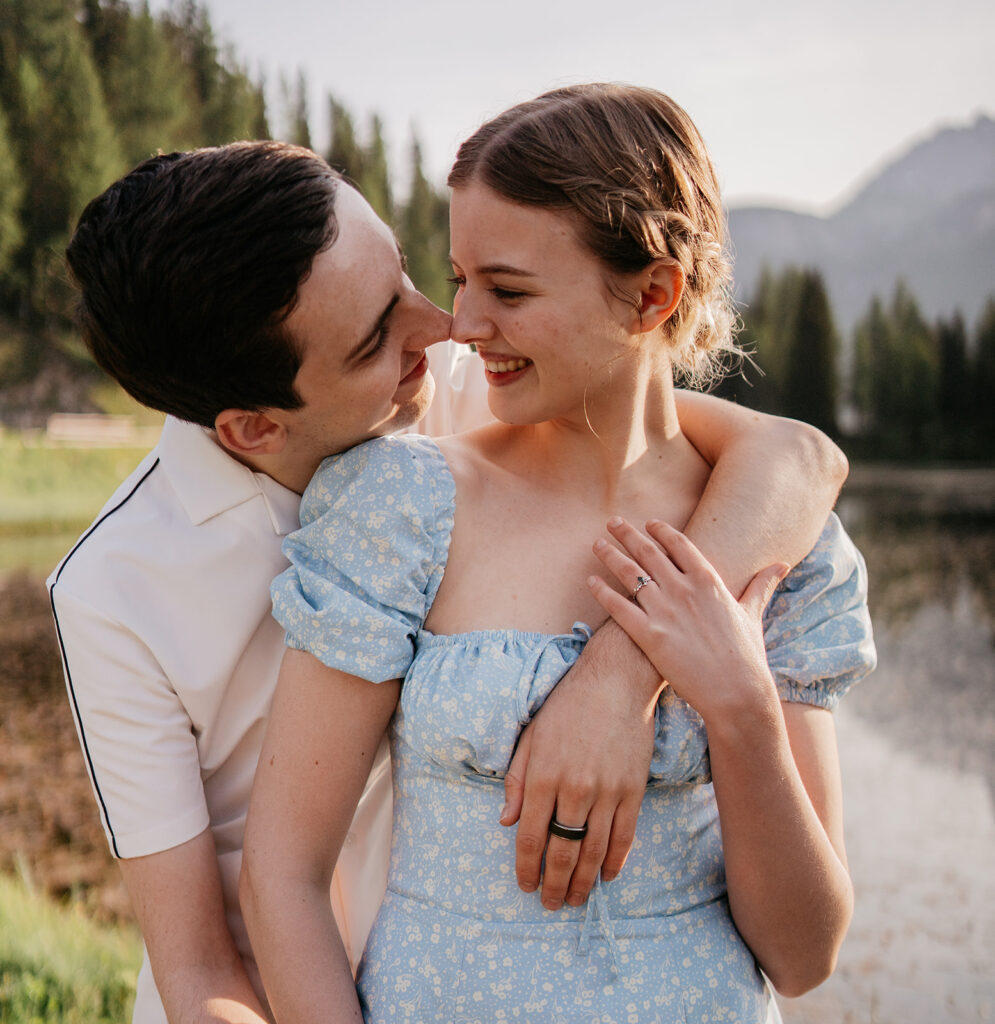 Couple embraces by scenic lakeside view