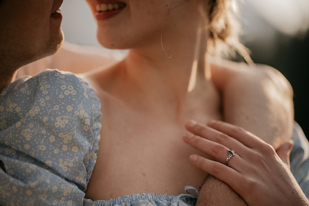 Close-up of person with engagement ring, smiling affectionately