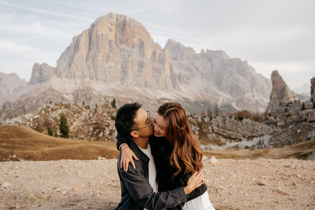 Couple embracing in front of mountain landscape