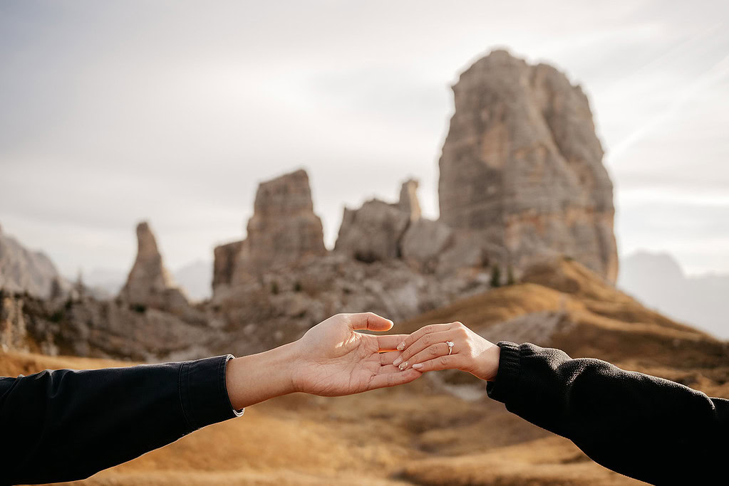 Hands touching in a mountain landscape