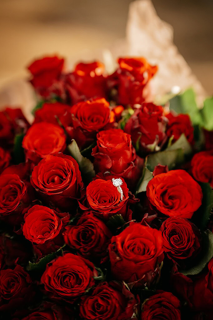 Bouquet of red roses with diamond ring.