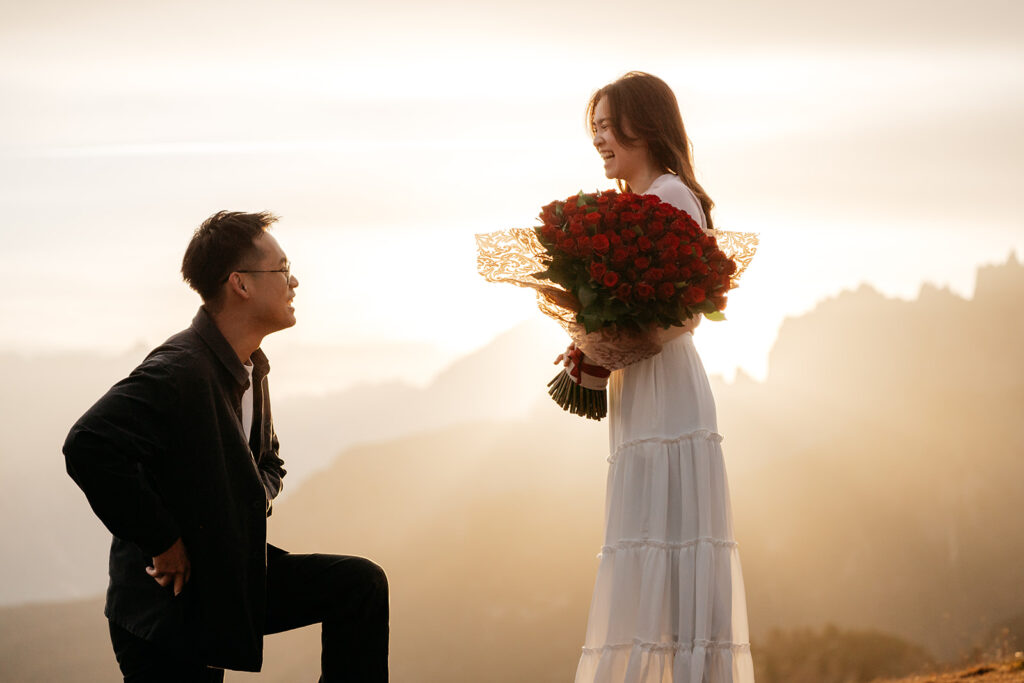 Romantic proposal at sunrise with rose bouquet