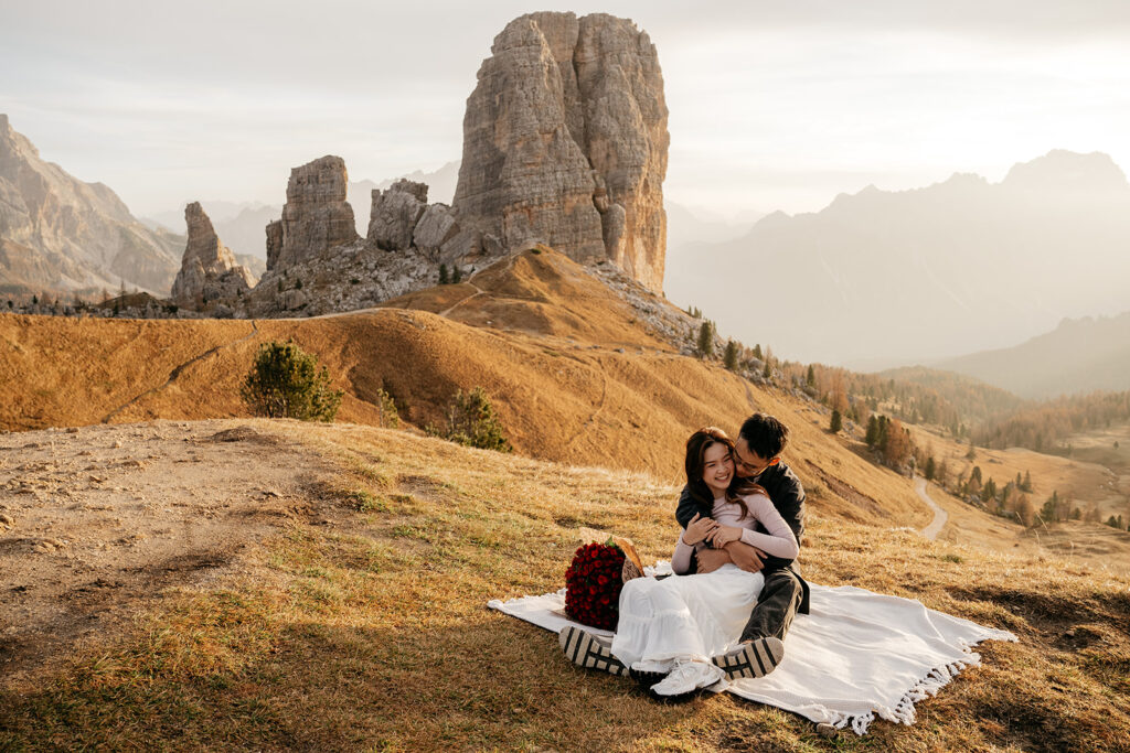 Couple embraces on picturesque mountain landscape