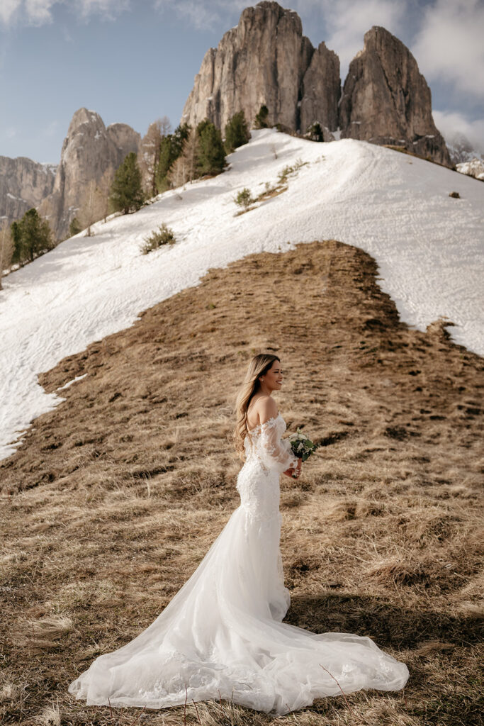 Bride in snowy mountain landscape