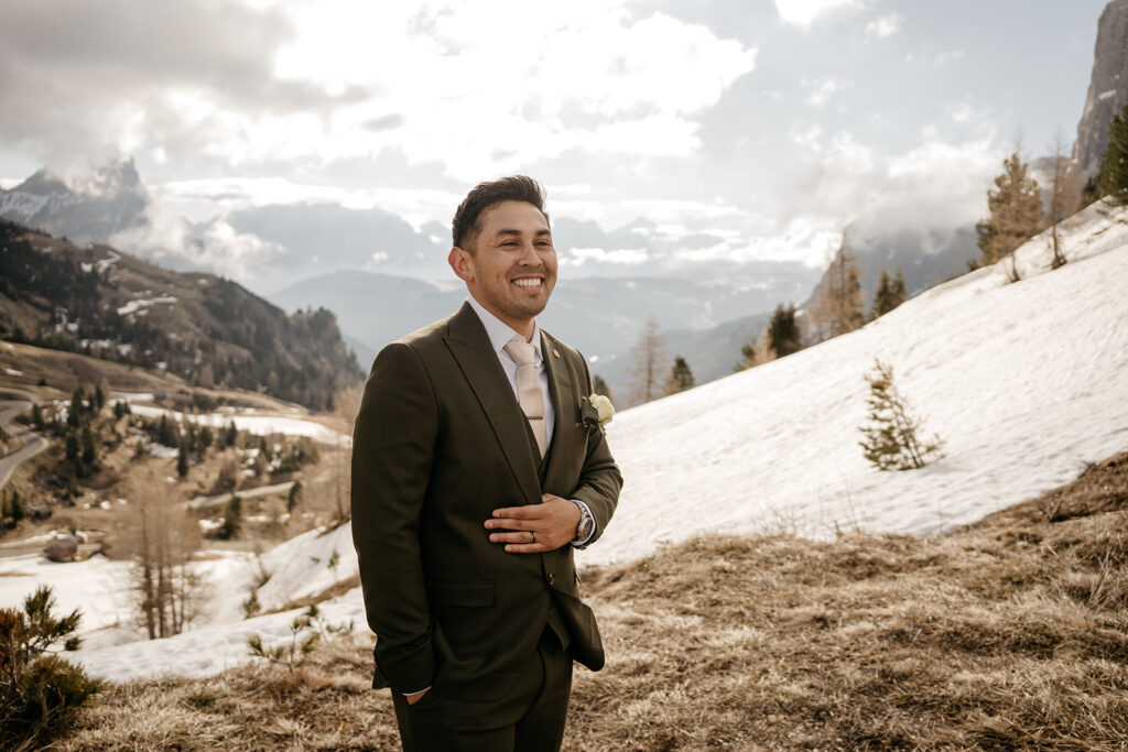 Smiling man in suit, snowy mountain backdrop