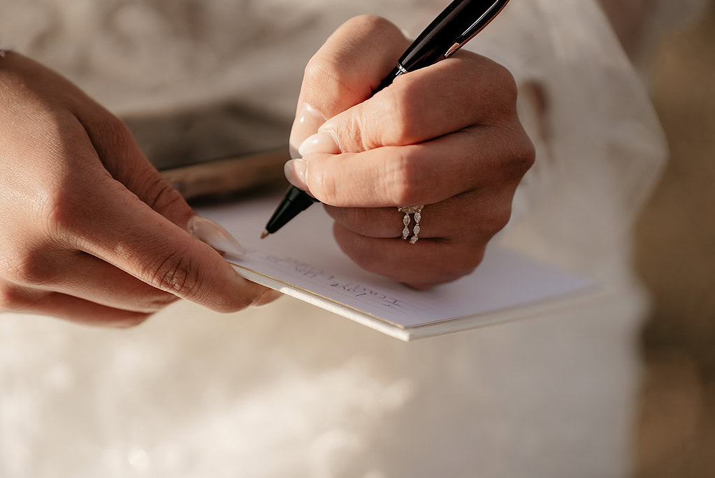 Handwriting on notepad with pen close-up