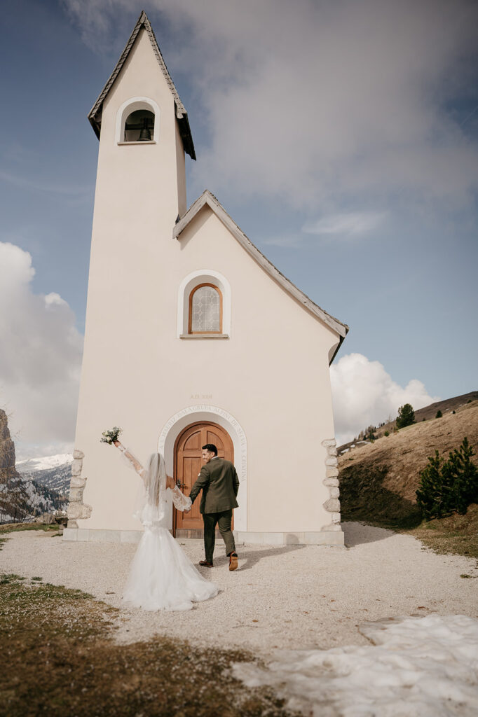 Bride and groom outside mountain chapel