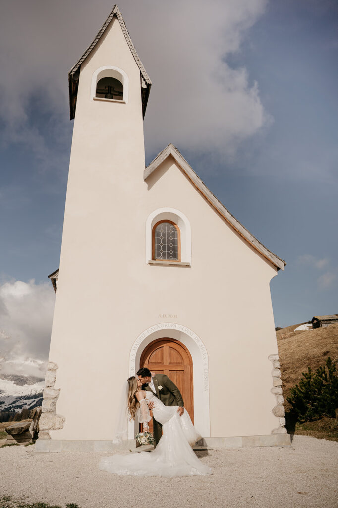 Bride and groom kissing at chapel wedding