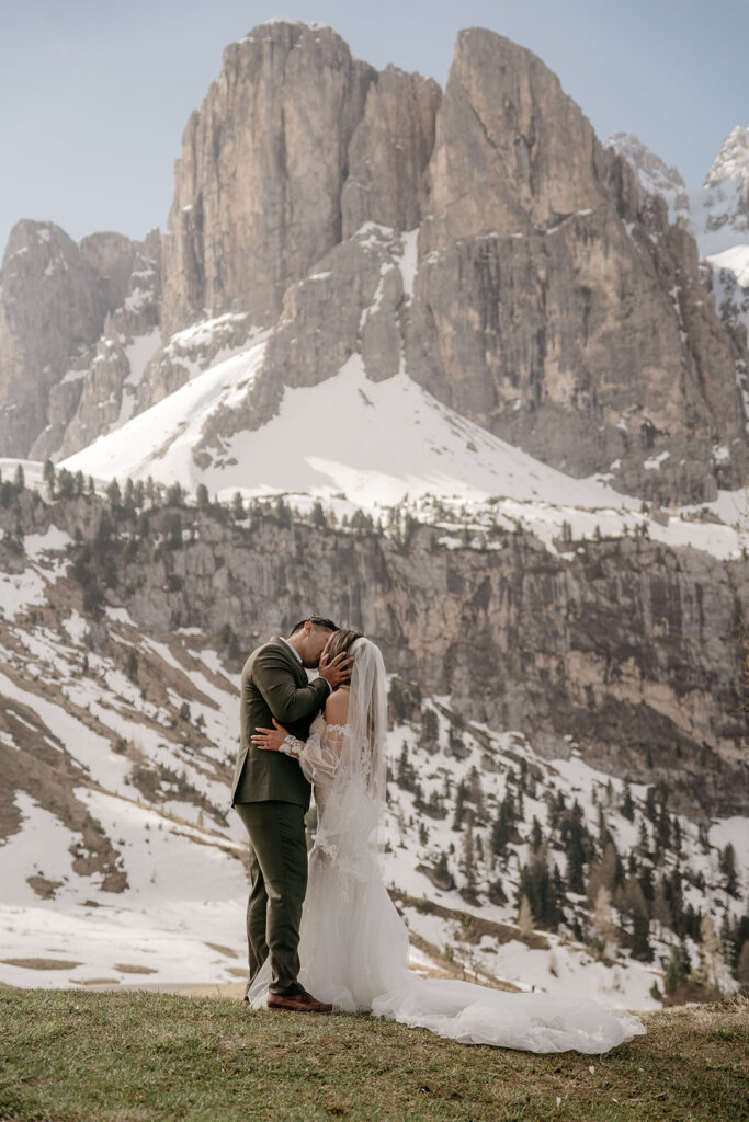 Couple kissing in snowy mountain landscape