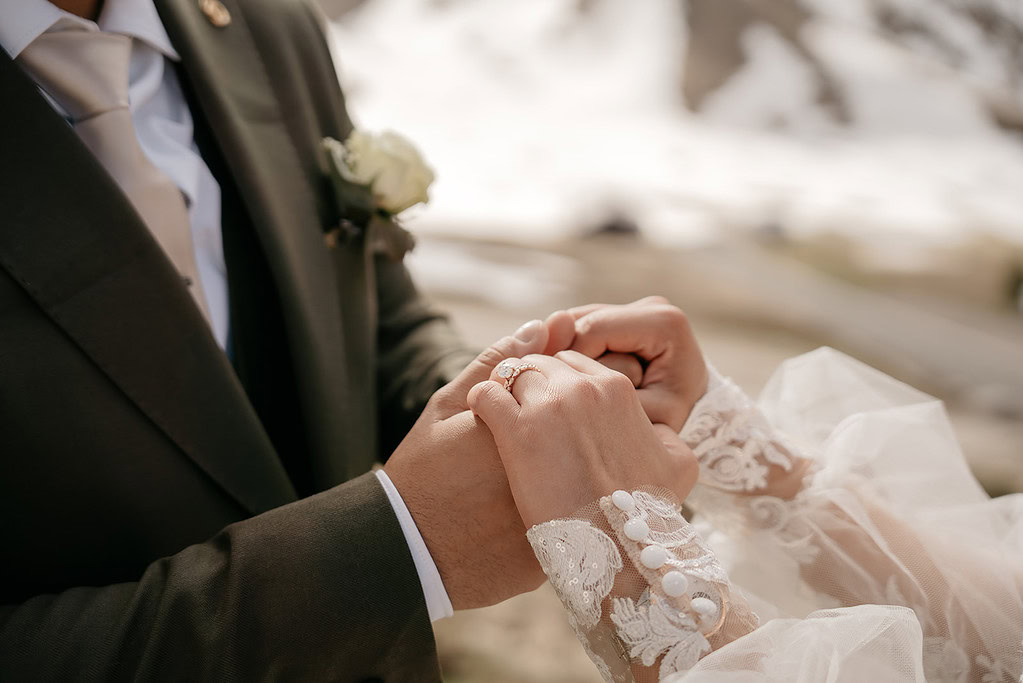 Bride and groom holding hands outdoors