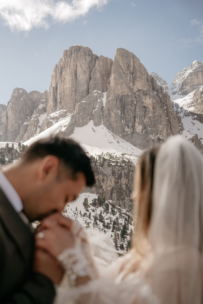 Couple kissing in snowy mountain landscape