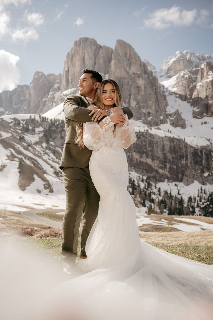 Couple embracing with snowy mountain backdrop