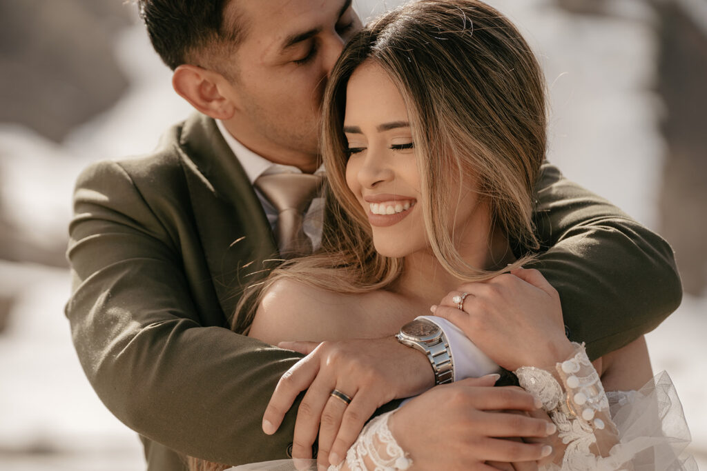 Smiling couple embracing outdoors.