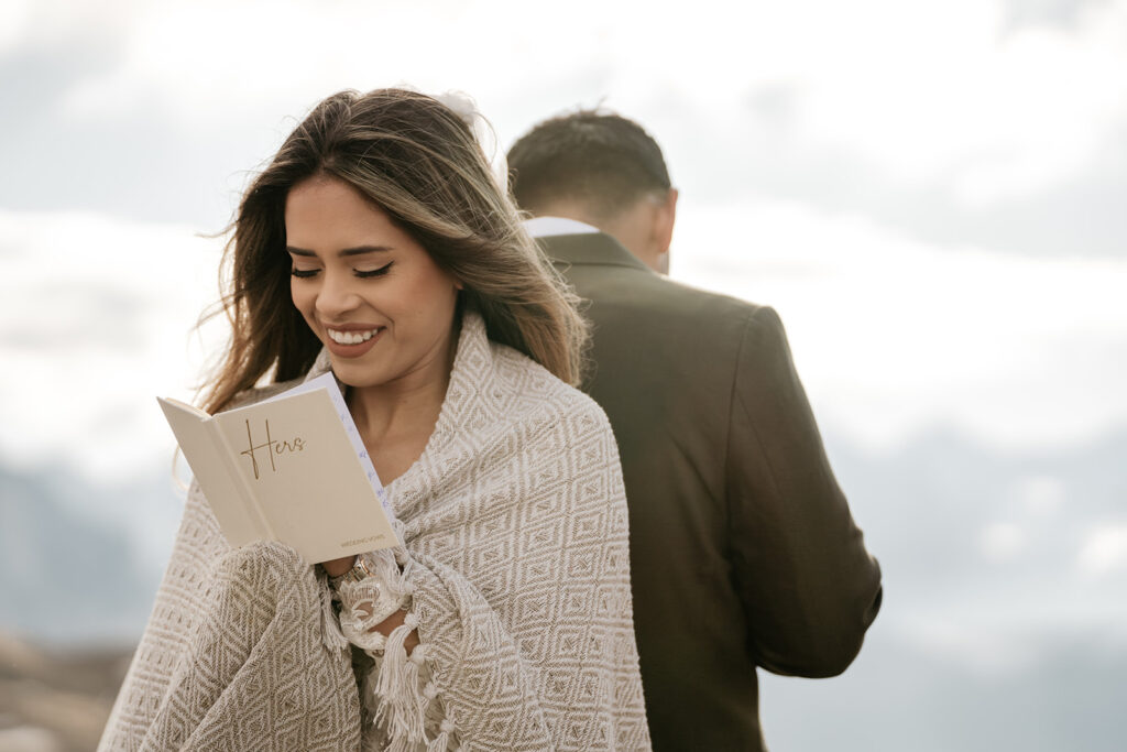 Woman reading vows outdoors, smiling warmly.