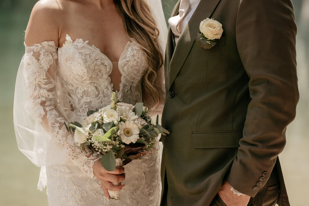 Bride and groom with white floral bouquet