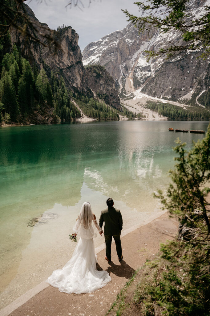 Bride and groom by mountain lake