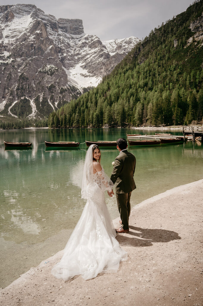 Bride and groom by mountain lake