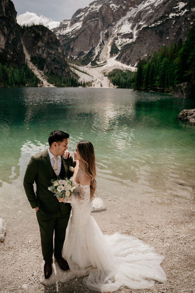 Bride and groom by mountain lake