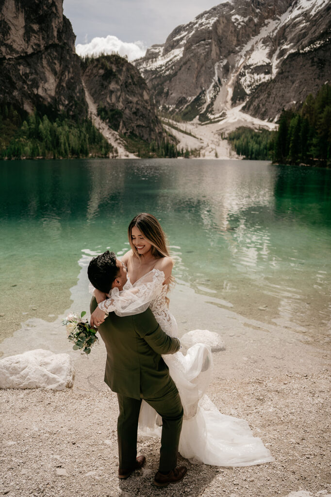 Bride and groom by mountain lake