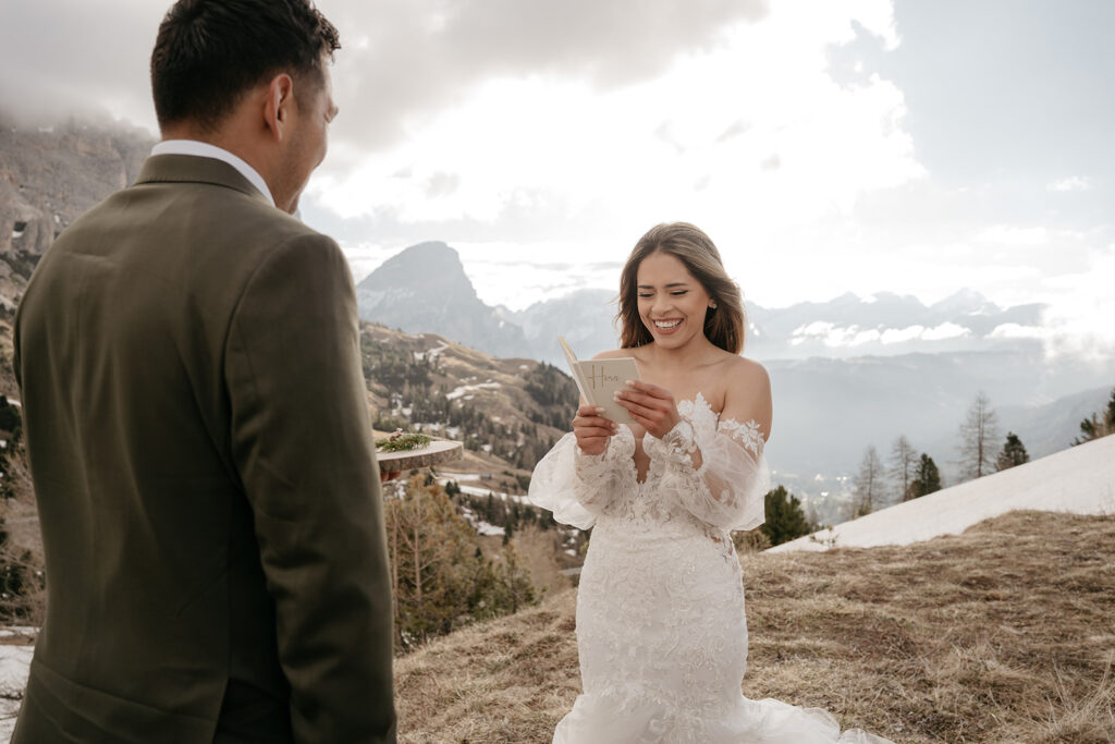 Bride reads vows to groom on mountain.