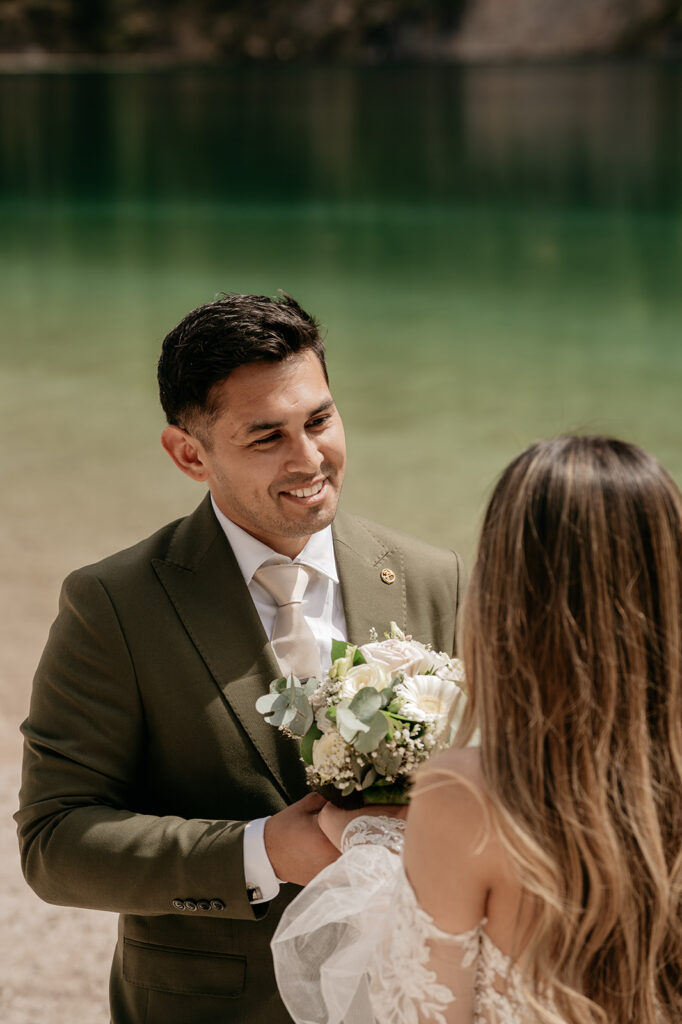 Couple exchanging vows by lake