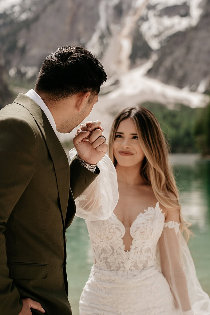 Bride and groom by scenic mountain lake