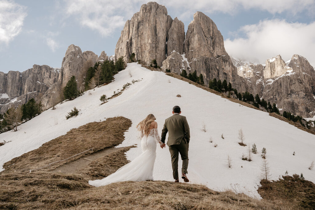 Couple walking on snowy mountain path