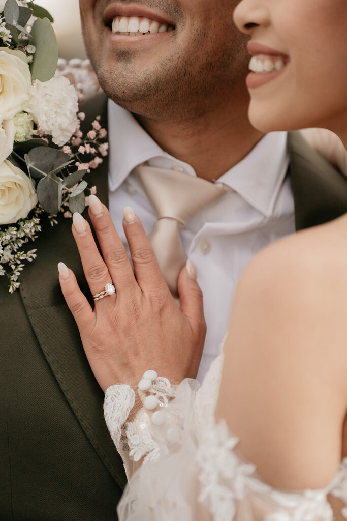 Bride's hand with ring and bouquet detail.