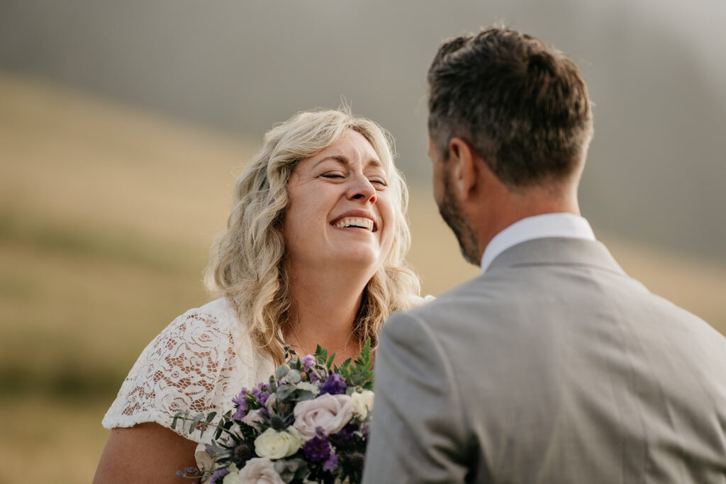 Couple smiling at an outdoor wedding ceremony