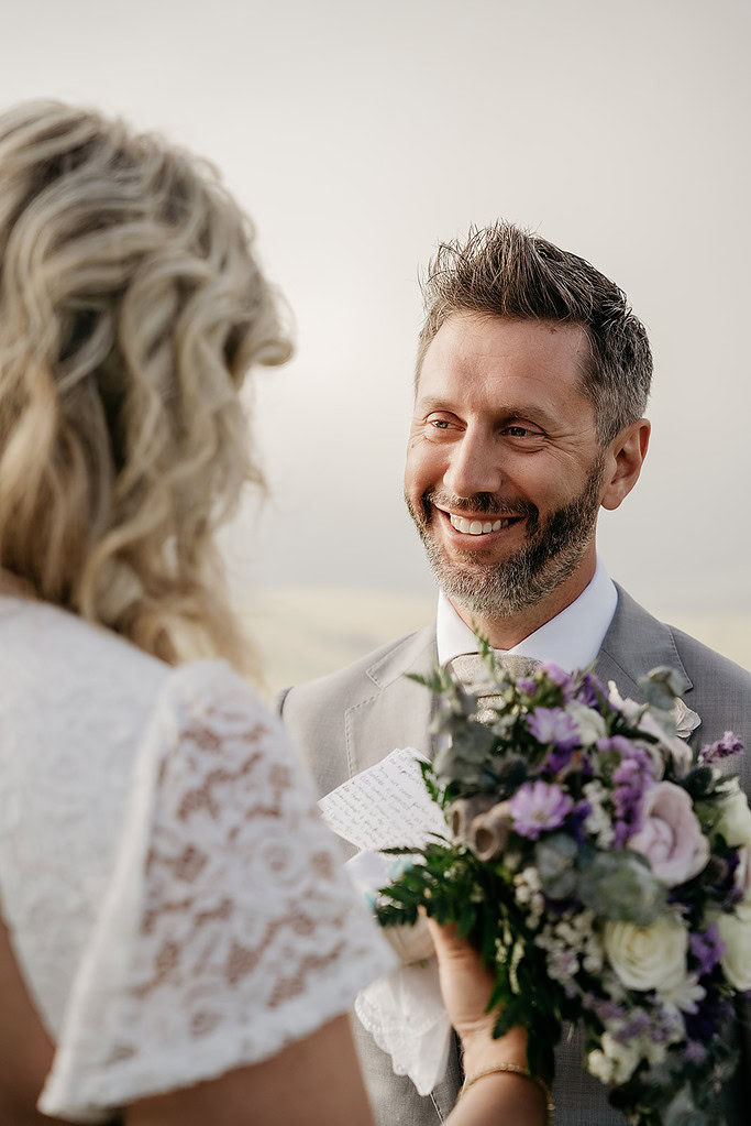 Bride and groom exchanging vows outdoors