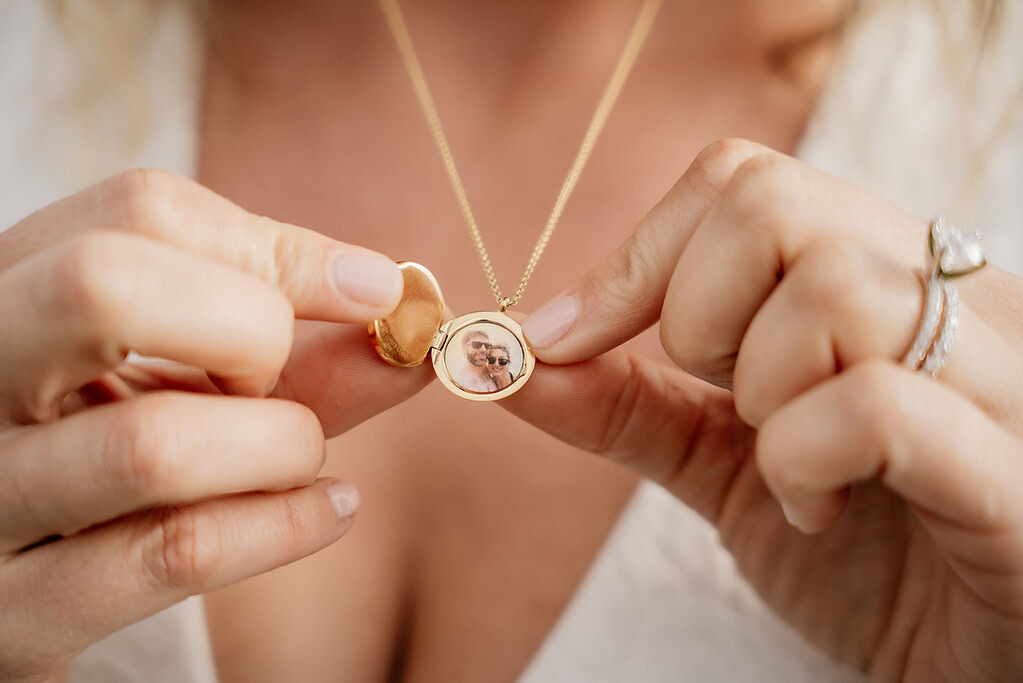 Woman holding locket with photo inside