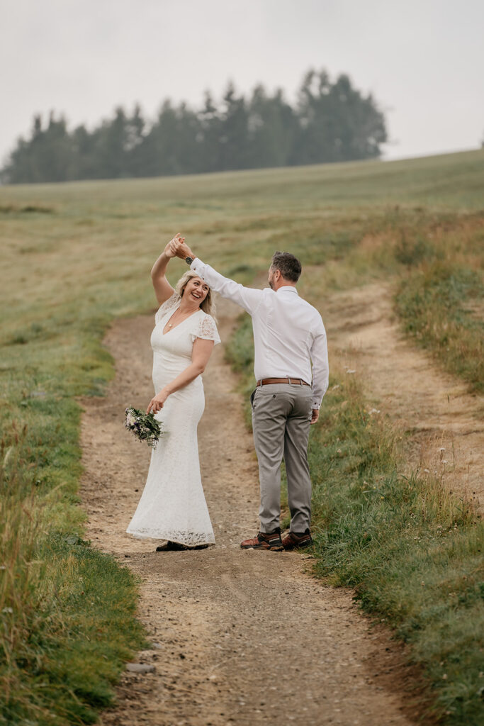 Couple dancing on a country path.