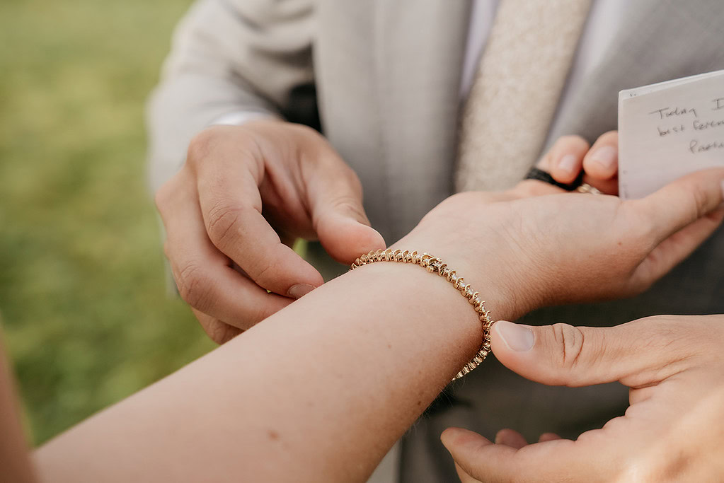 Person fastening elegant bracelet on wrist