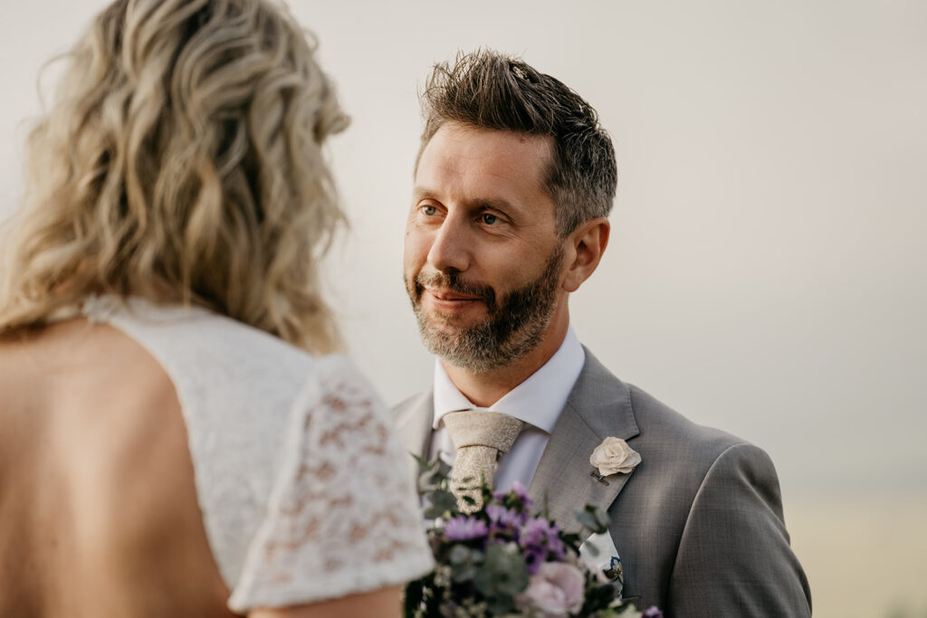 Bride and groom exchanging vows outdoors