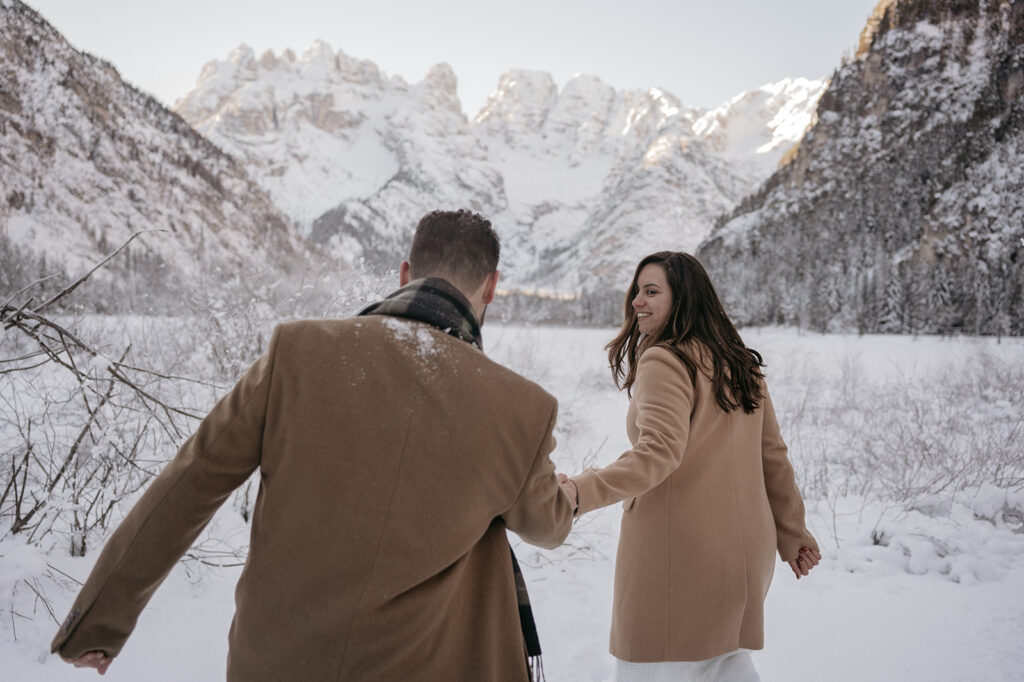 Couple walking in snowy mountain landscape