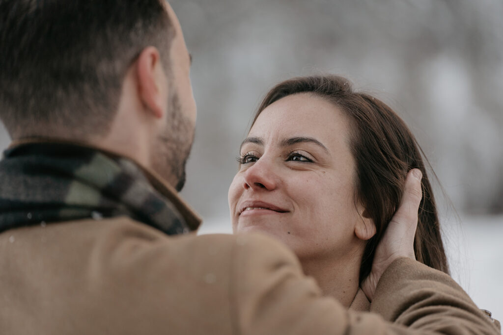 Smiling couple embracing outdoors in winter