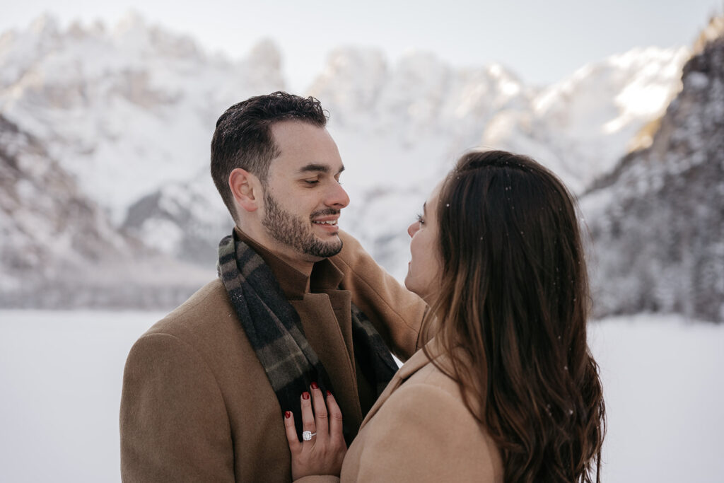 Couple embracing in snowy mountain landscape