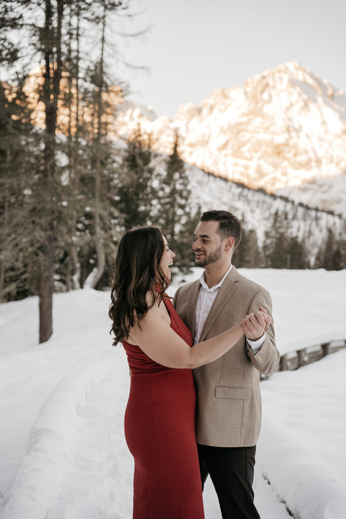 Couple dancing in snowy mountain landscape