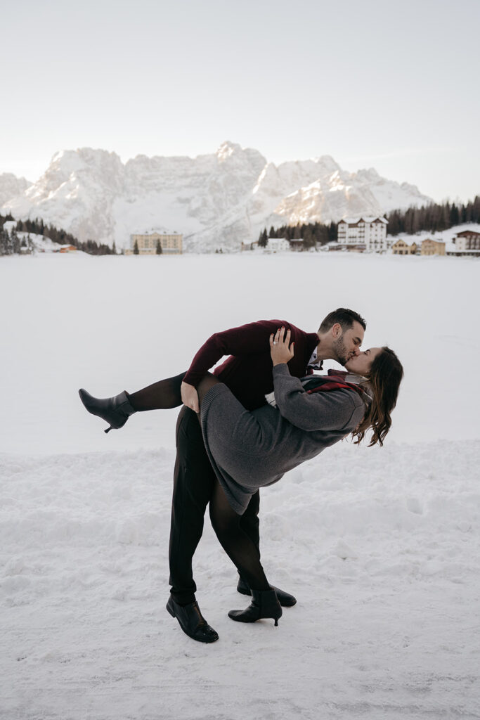 Couple kissing in snowy mountain landscape