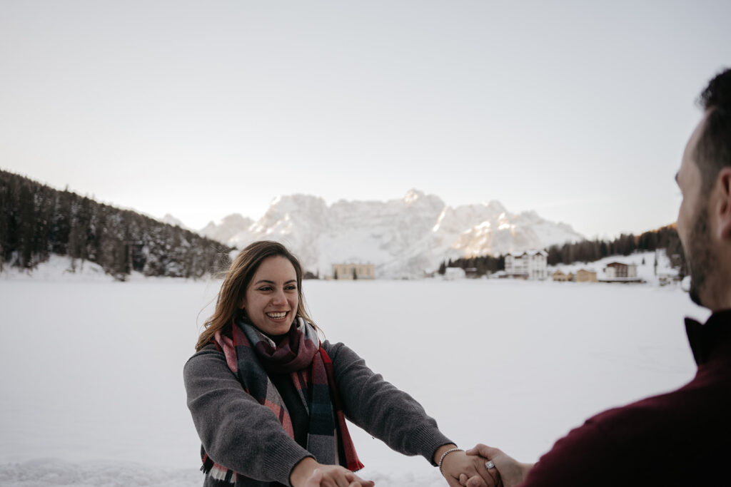 Couple holding hands on snowy landscape