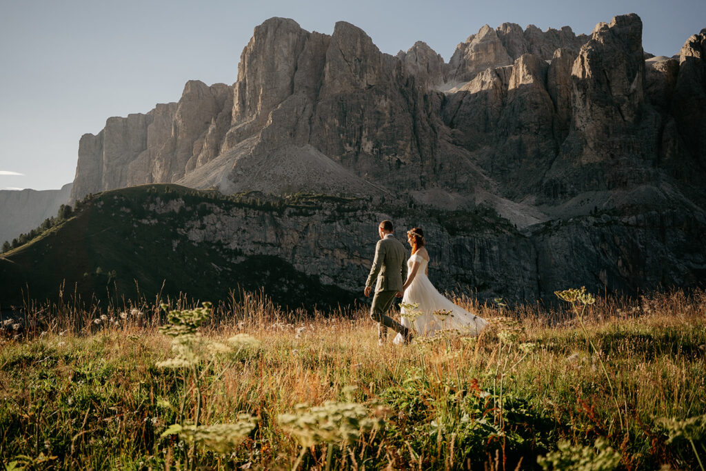 Couple walking in front of mountain landscape.